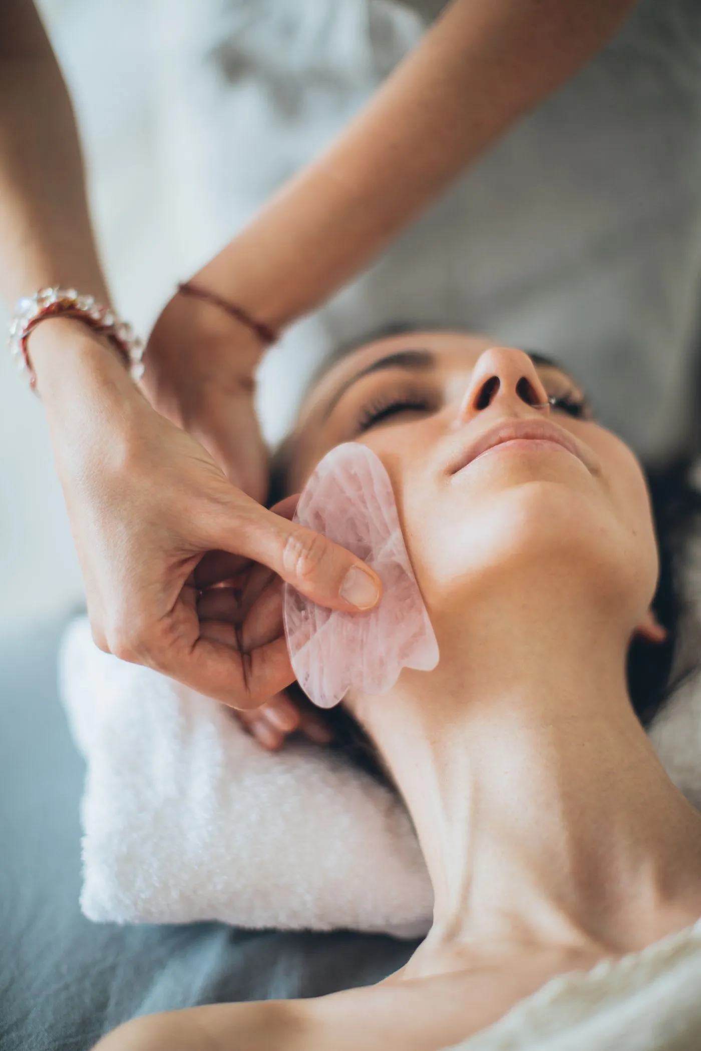 A practitioner using a gua sha tool during a calm session