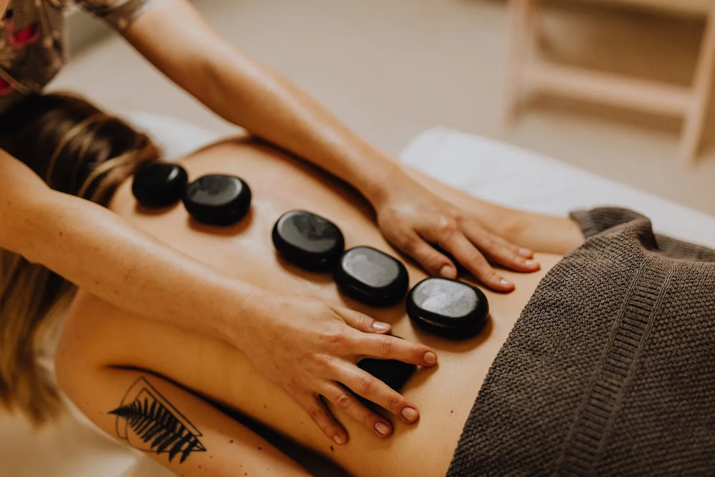 Hot stones placed during a restorative massage session