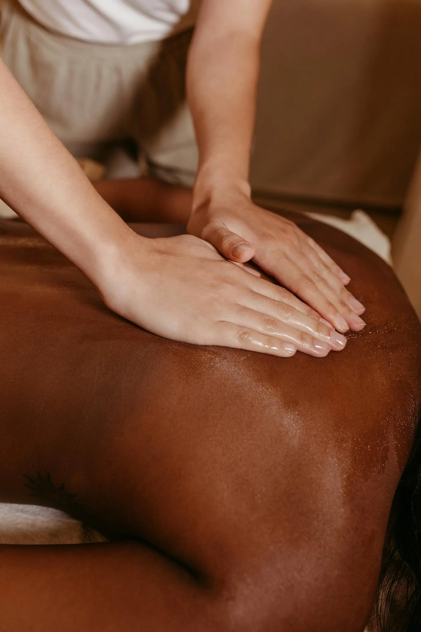 Massage therapist working with a client's shoulder